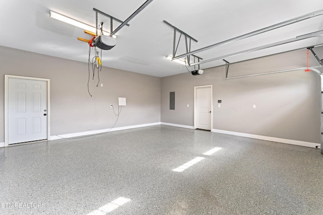8508 Flowering Peach Ln, Knoxville, TN 37923 - garage featuring baseboards, a garage door opener, and electric panel