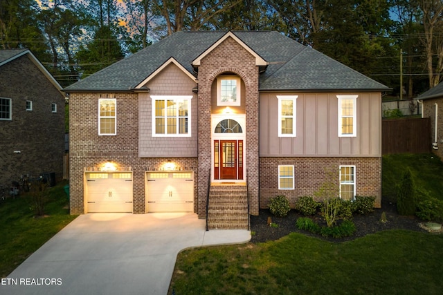 8508 Flowering Peach Ln, Knoxville, TN 37923 - bi-level home with a front lawn, brick siding, board and batten siding, an attached garage, and driveway