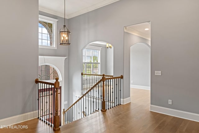8508 Flowering Peach Ln, Knoxville, TN 37923 - interior space featuring crown molding, arched walkways, a chandelier, and wood finished floors