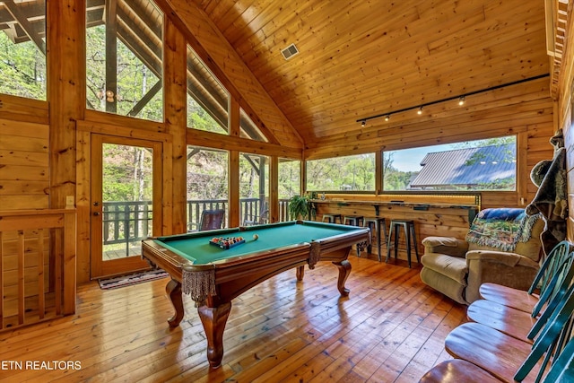 recreation room with billiards, wood-type flooring, high vaulted ceiling, and a wealth of natural light