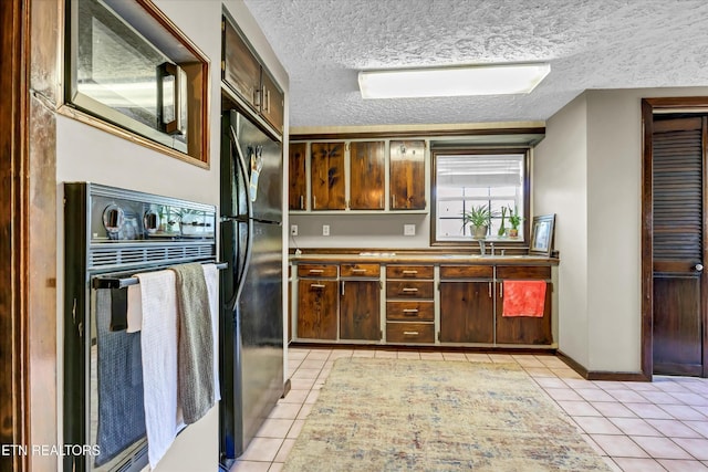 2220 Thorn Grove Pike, Knoxville, TN 37914 - kitchen featuring light tile patterned floors, black appliances, and a textured ceiling