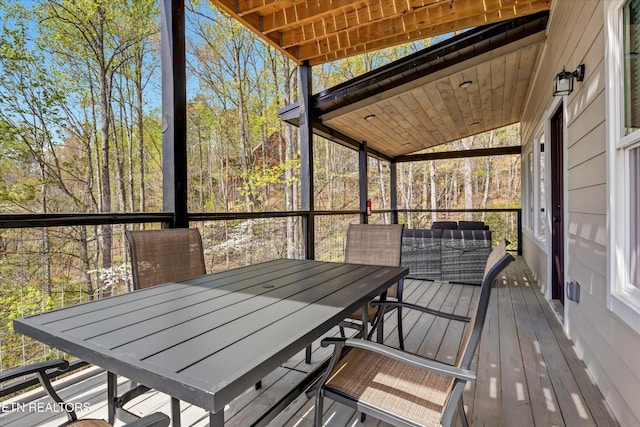 unfurnished sunroom featuring outdoor dining area