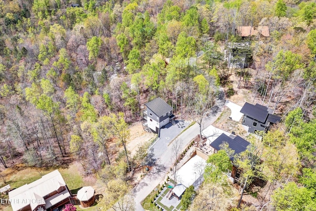 drone / aerial view featuring a forest view