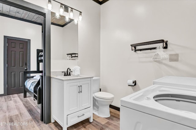full bathroom featuring vanity, wood finished floors, and toilet