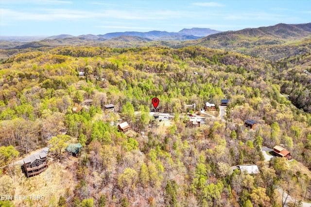 drone / aerial view with a mountain view and a forest view