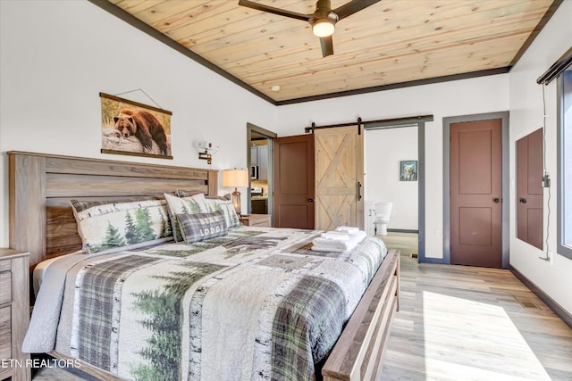 bedroom with connected bathroom, a barn door, baseboards, light wood-type flooring, and wood ceiling