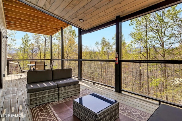 sunroom / solarium featuring outdoor lounge area and outdoor dining area