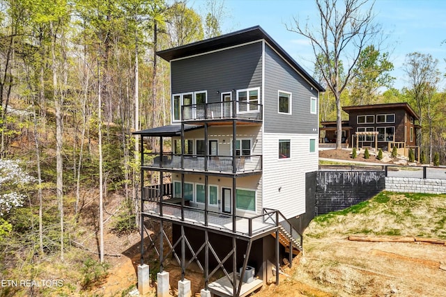 rear view of house featuring a balcony