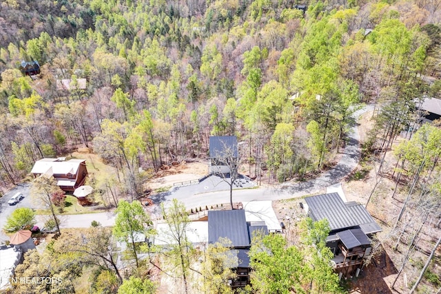 drone / aerial view featuring a wooded view
