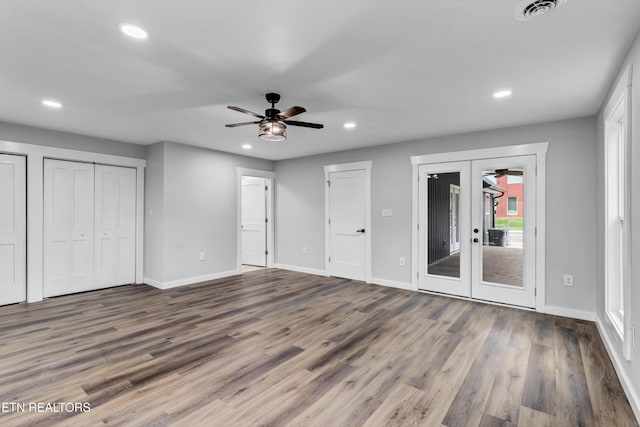 unfurnished bedroom with access to outside, baseboards, recessed lighting, and wood finished floors