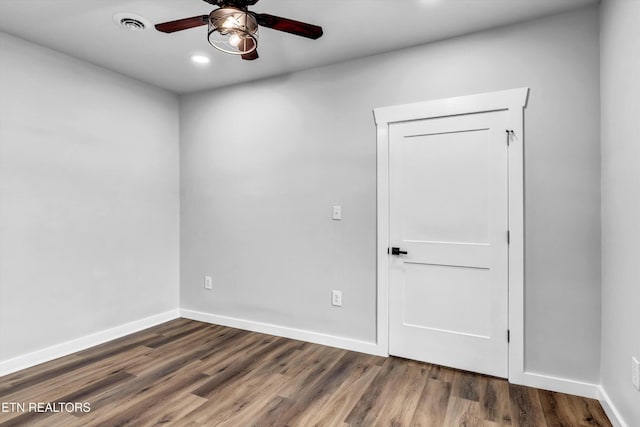 spare room with a ceiling fan, baseboards, recessed lighting, and wood finished floors