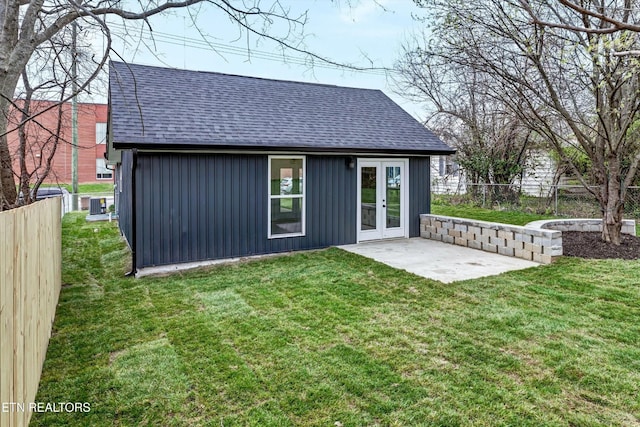 view of outbuilding with french doors, central AC unit, and a fenced backyard