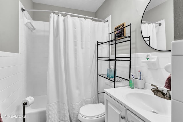 1606 Sexton Ln, Knoxville, TN 37932 - bathroom with vanity, shower / bath combo with shower curtain, toilet, tile walls, and a wainscoted wall