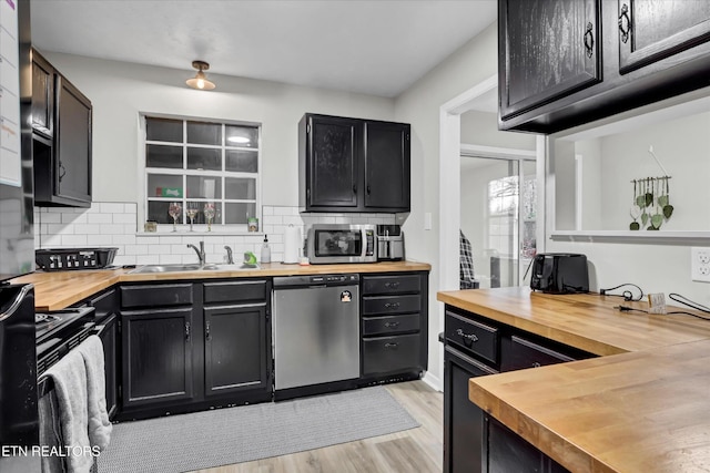 1606 Sexton Ln, Knoxville, TN 37932 - kitchen with a sink, appliances with stainless steel finishes, dark cabinetry, and butcher block counters