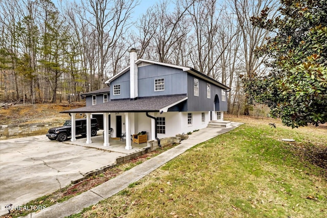 1606 Sexton Ln, Knoxville, TN 37932 - view of front of house featuring a shingled roof, a chimney, concrete driveway, and a front yard