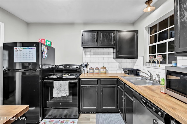 1606 Sexton Ln, Knoxville, TN 37932 - kitchen featuring decorative backsplash, a sink, black appliances, dark cabinets, and wood counters