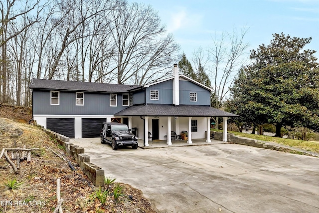 1606 Sexton Ln, Knoxville, TN 37932 - view of front facade with a garage, covered porch, driveway, and roof with shingles