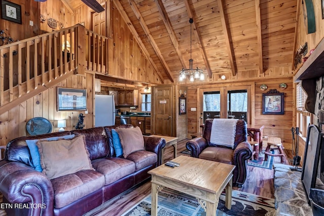 living area with wood ceiling, beamed ceiling, wood walls, and wood finished floors