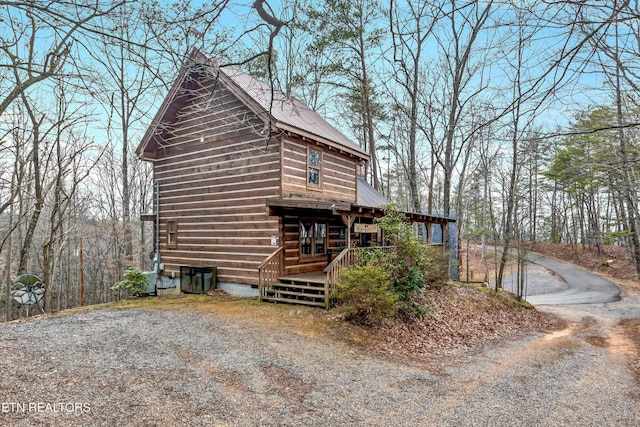 view of property exterior with crawl space, central AC, metal roof, and a deck