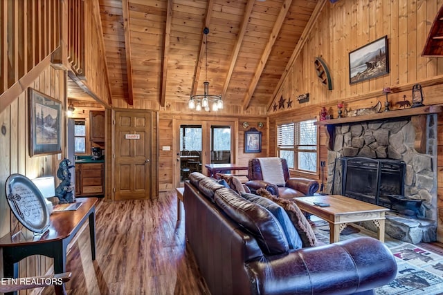 living room with wooden walls, wooden ceiling, and wood finished floors