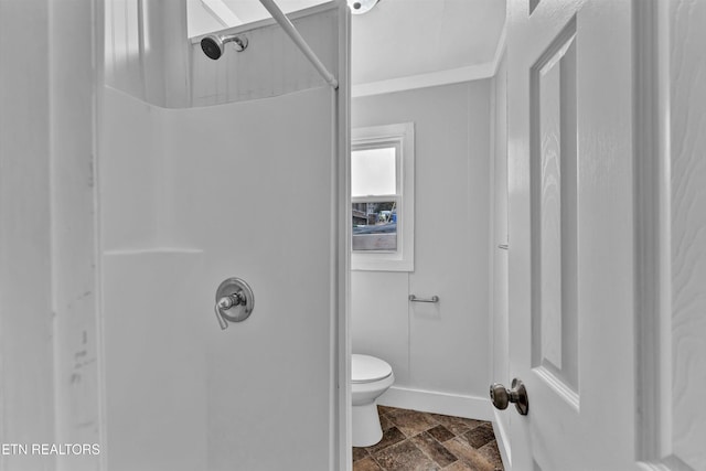 full bathroom with baseboards, toilet, a shower, and stone tile floors