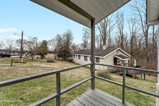 wooden deck featuring a yard