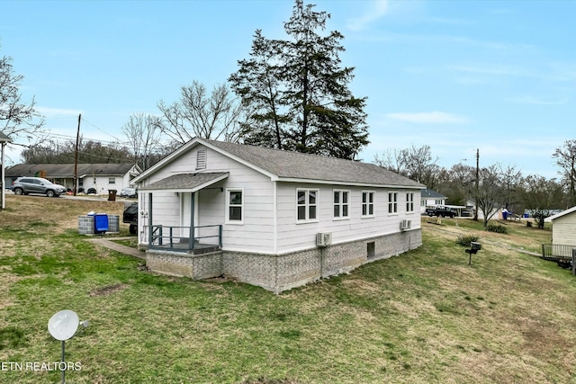 view of side of property with a lawn and roof with shingles