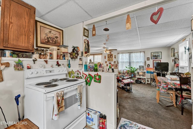 kitchen with brown cabinetry, a drop ceiling, and white range with electric stovetop
