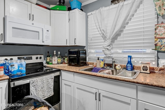 565567 W Outer Dr, Oak Ridge, TN 37830 - kitchen with white cabinetry, stainless steel electric range, a sink, and white microwave