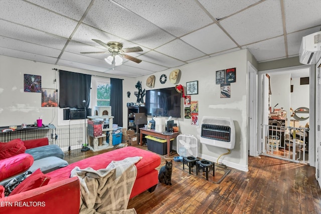 565567 W Outer Dr, Oak Ridge, TN 37830 - living area featuring ceiling fan, wood-type flooring, heating unit, a drop ceiling, and a wall unit AC