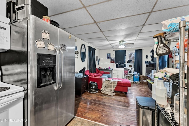565567 W Outer Dr, Oak Ridge, TN 37830 - interior space featuring wood finished floors, ceiling fan, a drop ceiling, stainless steel refrigerator with ice dispenser, and white electric stove