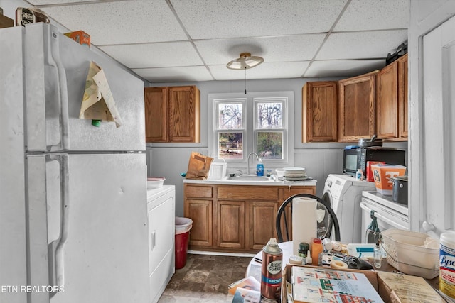 laundry area with a sink, laundry area, and washer and clothes dryer