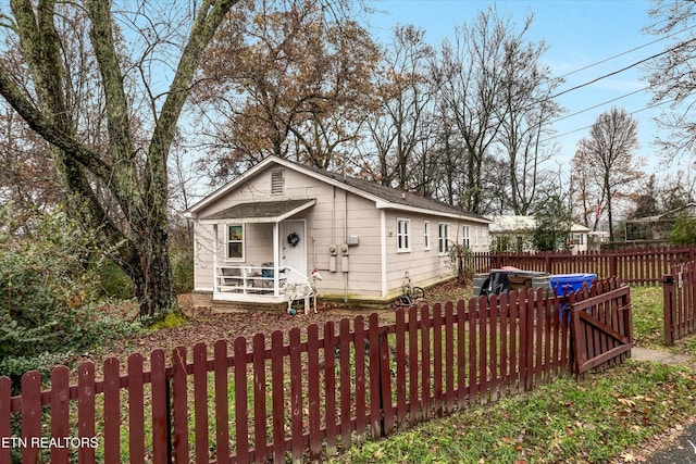 bungalow-style house featuring a fenced backyard and a shingled roof