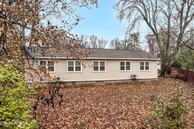 exterior space with fence and a shingled roof