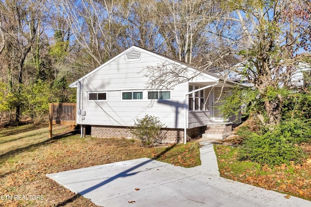 bungalow with a patio and a front lawn