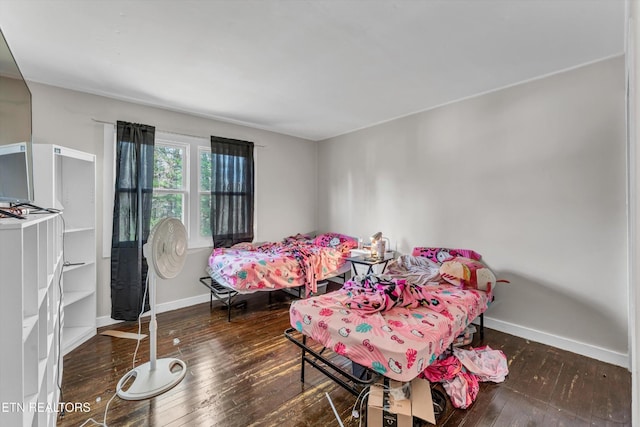 bedroom featuring wood-type flooring and baseboards