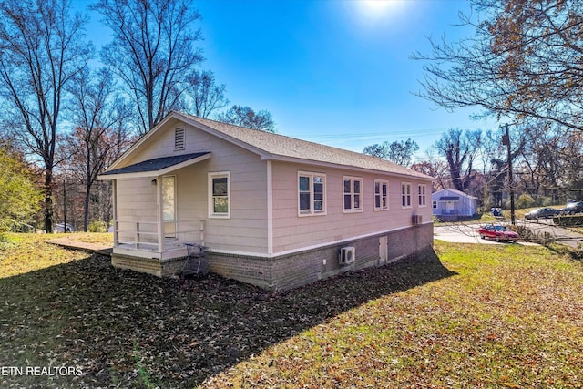 view of property exterior featuring a lawn and roof with shingles