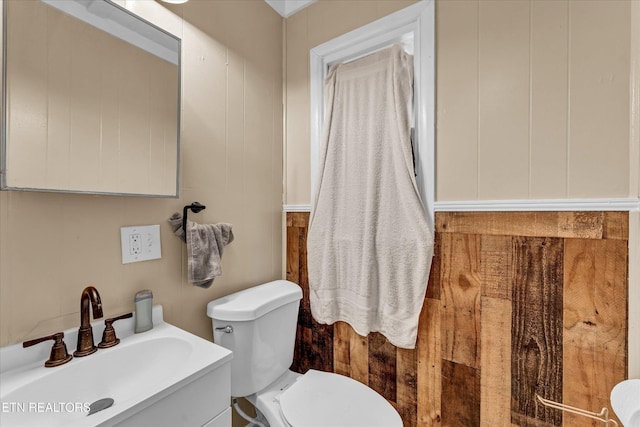 half bath featuring vanity and toilet