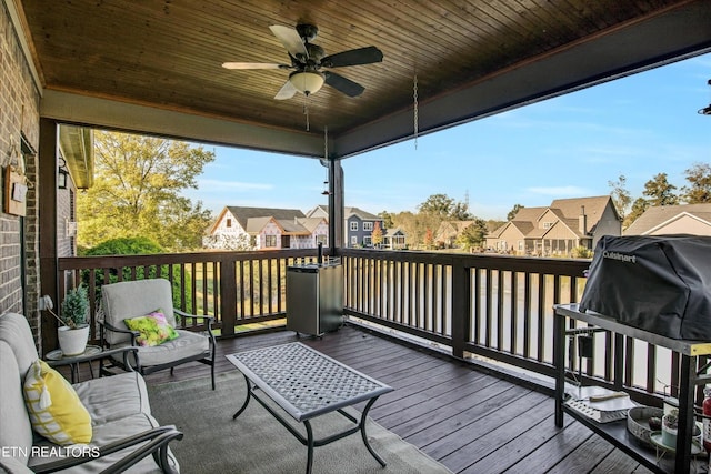 wooden deck featuring a ceiling fan and a residential view