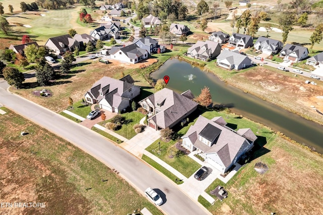 drone / aerial view featuring a residential view and a water view