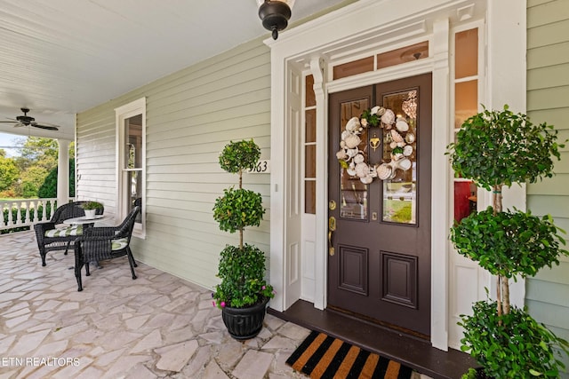 doorway to property featuring a ceiling fan and covered porch