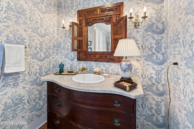 bathroom with vanity and wallpapered walls