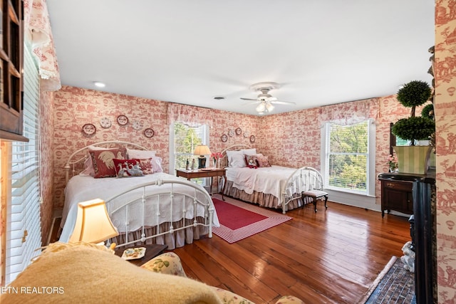 bedroom with wood-type flooring and wallpapered walls