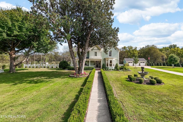 traditional-style house featuring a garage and a front lawn