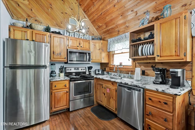 kitchen featuring light stone countertops, vaulted ceiling, a sink, wooden ceiling, and stainless steel appliances