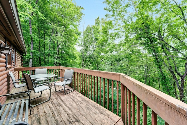 wooden terrace featuring outdoor dining area