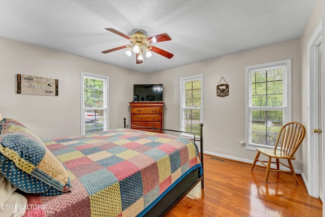 3178 N Clear Fork Rd, Sevierville, TN 37862 - bedroom with visible vents, multiple windows, and wood finished floors
