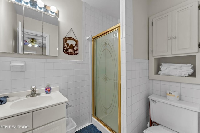 3178 N Clear Fork Rd, Sevierville, TN 37862 - bathroom featuring vanity, a shower stall, toilet, and tile walls