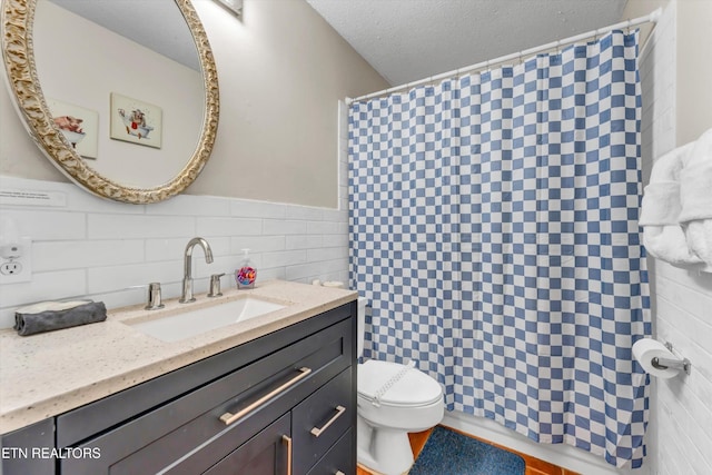 3178 N Clear Fork Rd, Sevierville, TN 37862 - bathroom with vanity, toilet, a textured ceiling, a shower with shower curtain, and tile walls