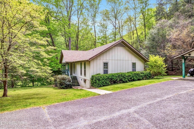 3178 N Clear Fork Rd, Sevierville, TN 37862 - view of front facade featuring roof with shingles, stairs, board and batten siding, and a front lawn